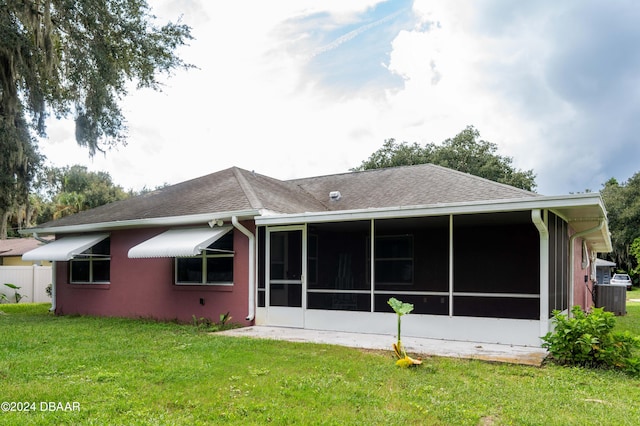 back of house featuring a sunroom, cooling unit, and a yard