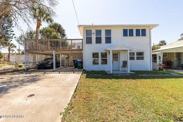 view of front of property with a wooden deck, a front lawn, and a carport