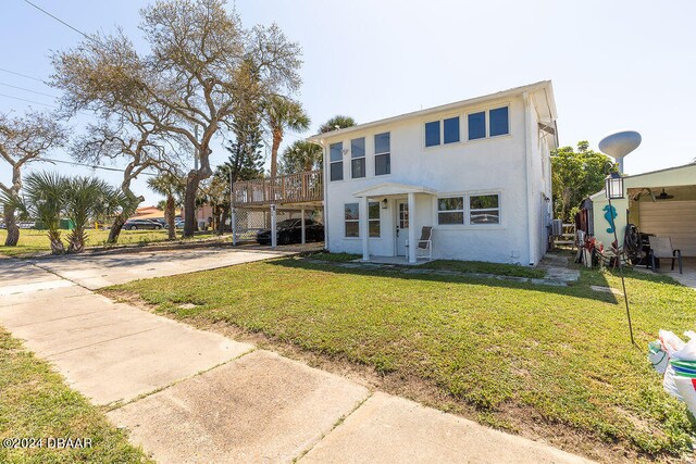 view of front of house with a front lawn and a deck