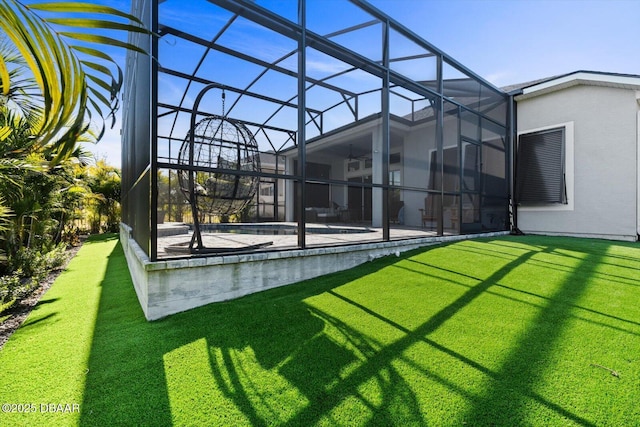 rear view of property with a lanai, a patio, and a lawn