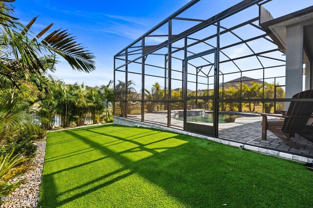 view of pool with a patio area and glass enclosure