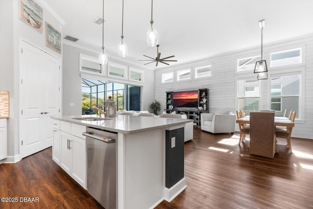 kitchen featuring pendant lighting, sink, white cabinetry, and a center island with sink