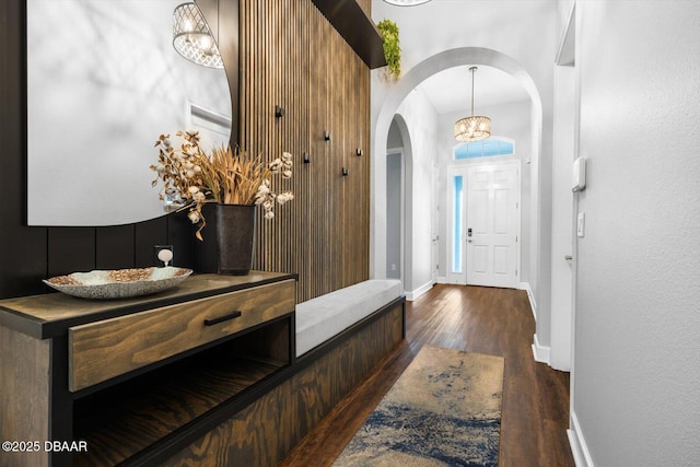 foyer with dark hardwood / wood-style floors and a notable chandelier