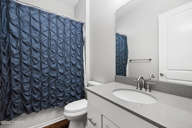 full bathroom with vanity, shower / bath combo with shower curtain, and toilet