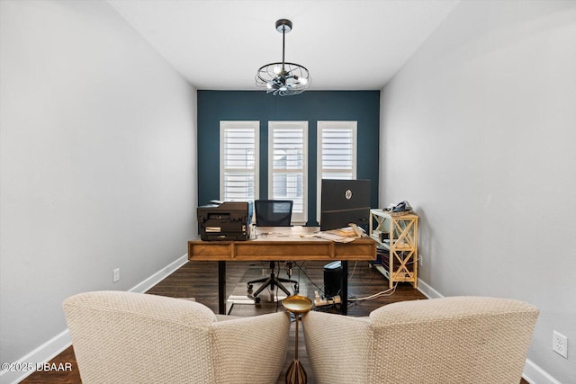 home office featuring hardwood / wood-style floors and an inviting chandelier