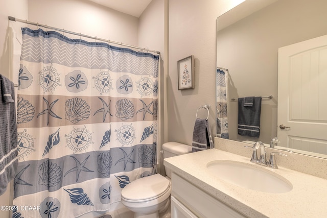 bathroom featuring a shower with shower curtain, vanity, and toilet