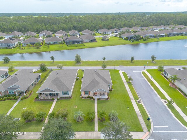 birds eye view of property with a water view and a residential view