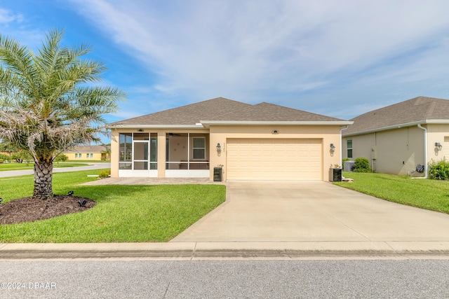 view of front of home featuring a front lawn, an attached garage, a sunroom, and stucco siding