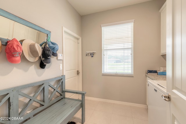 mudroom with light tile patterned floors, washer / dryer, and baseboards