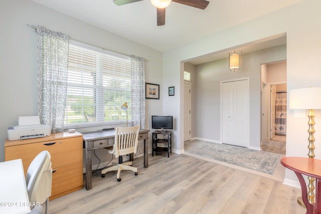 office space with light wood-type flooring, baseboards, and a ceiling fan