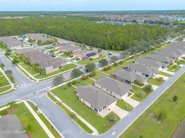 birds eye view of property featuring a residential view and a wooded view