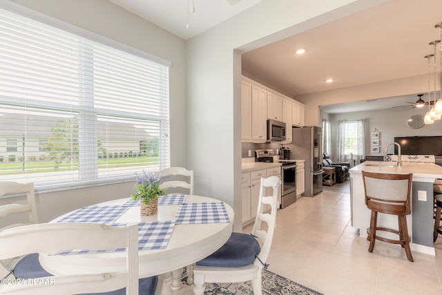 dining area featuring light tile patterned floors, a ceiling fan, and recessed lighting