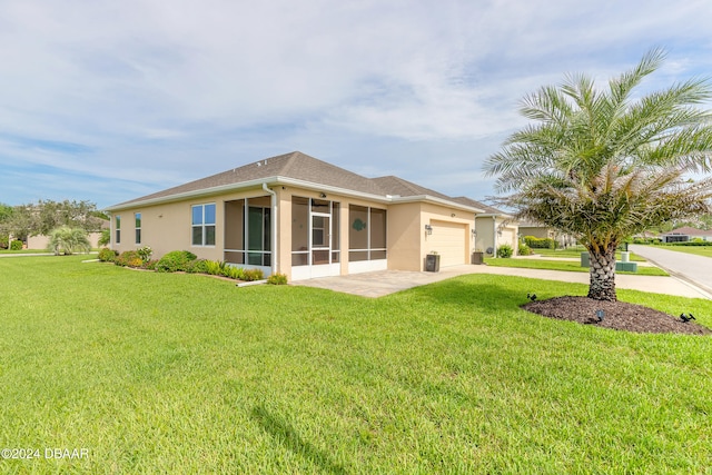 view of front facade featuring a garage, a front yard, a sunroom, and driveway