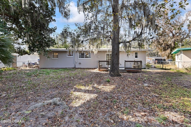 back of property featuring a deck