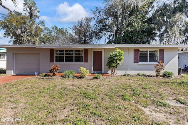 single story home with a garage and a front yard