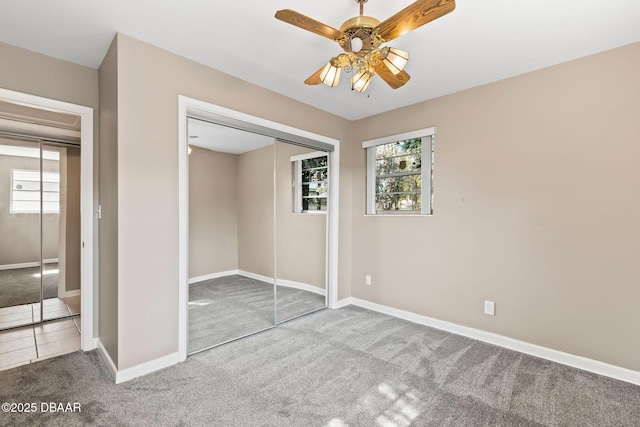 unfurnished bedroom featuring a closet, ceiling fan, and carpet flooring