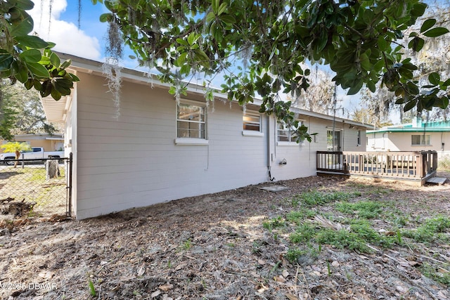 rear view of house with a wooden deck