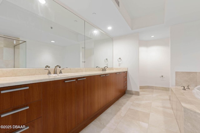 full bath with double vanity, a tub, a sink, and recessed lighting