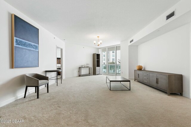 231 Riverside Dr Unit 304-1, Daytona Beach, FL 32117 - living room with baseboards, carpet flooring, visible vents, and a chandelier