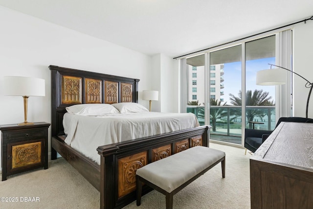 231 Riverside Dr Unit 304-1, Daytona Beach, FL 32117 - bedroom featuring floor to ceiling windows, light carpet, and access to exterior