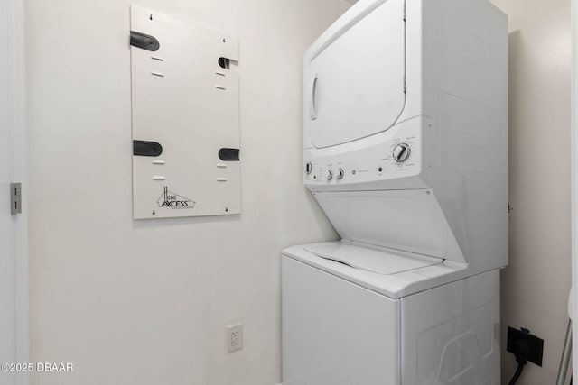 laundry area featuring laundry area and stacked washer and clothes dryer