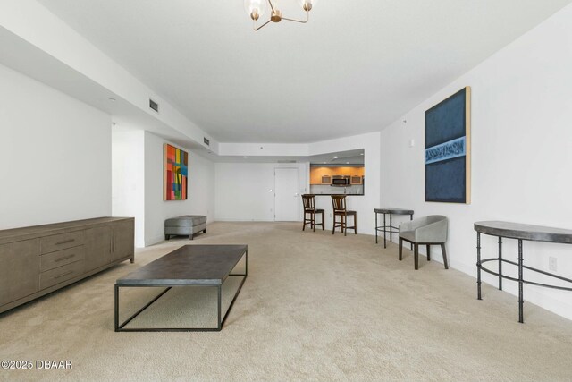 231 Riverside Dr Unit 304-1, Daytona Beach, FL 32117 - carpeted living room featuring visible vents and a chandelier