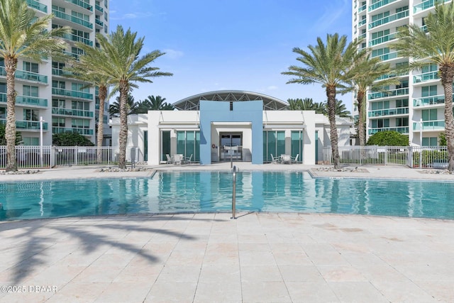 pool featuring a patio area and fence