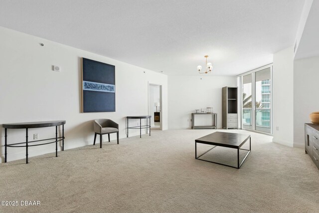 231 Riverside Dr Unit 304-1, Daytona Beach, FL 32117 - spare room featuring baseboards, a chandelier, a wall of windows, and light colored carpet