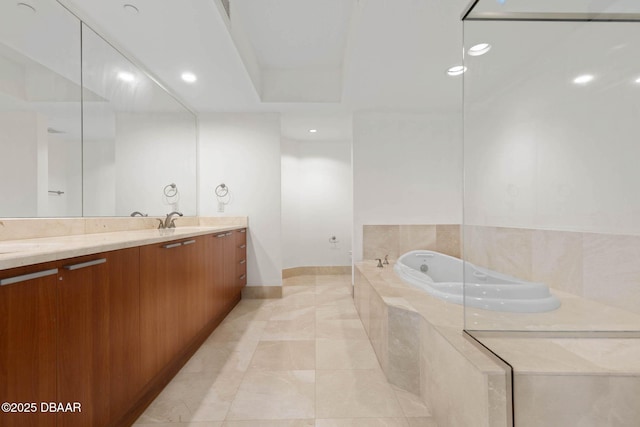 bathroom featuring double vanity, a sink, a bath, and recessed lighting