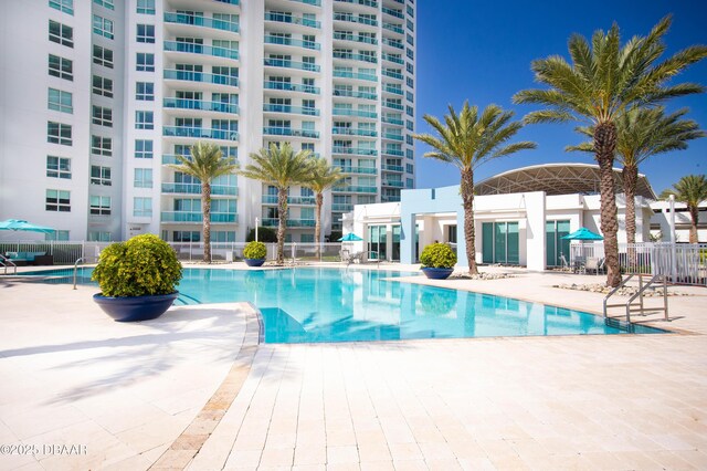 231 Riverside Dr Unit 304-1, Daytona Beach, FL 32117 - community pool with a patio and fence