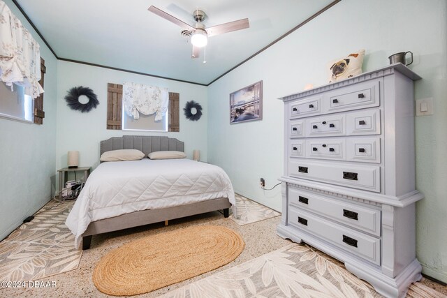 bedroom with ceiling fan and crown molding