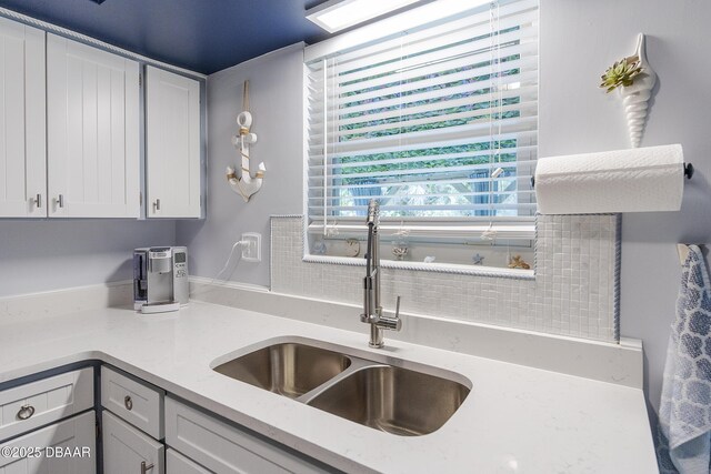 kitchen with exhaust hood, white appliances, and white cabinetry