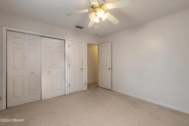 unfurnished bedroom with ceiling fan and light colored carpet