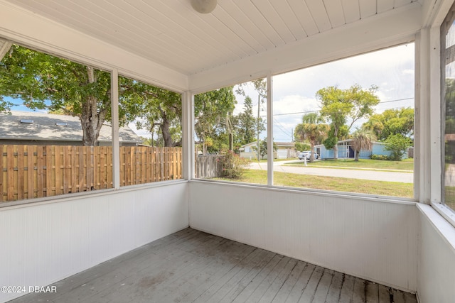 unfurnished sunroom with wooden ceiling and plenty of natural light