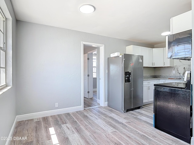 kitchen with light wood finished floors, baseboards, white cabinetry, and stainless steel refrigerator with ice dispenser