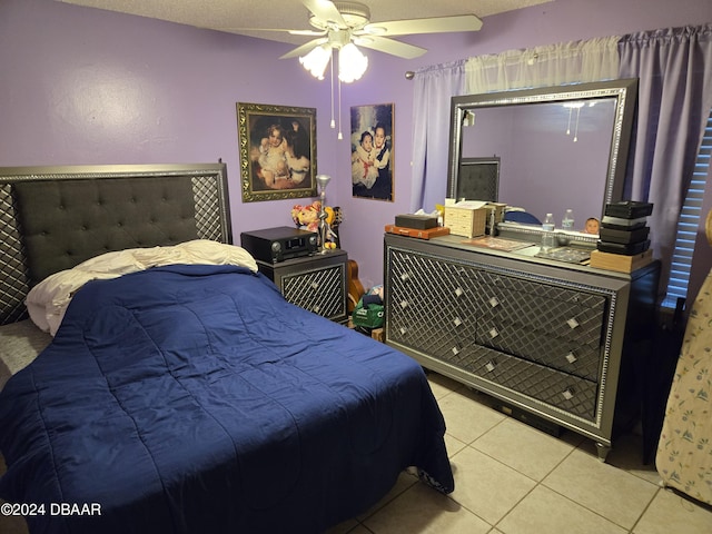 tiled bedroom featuring a textured ceiling and ceiling fan