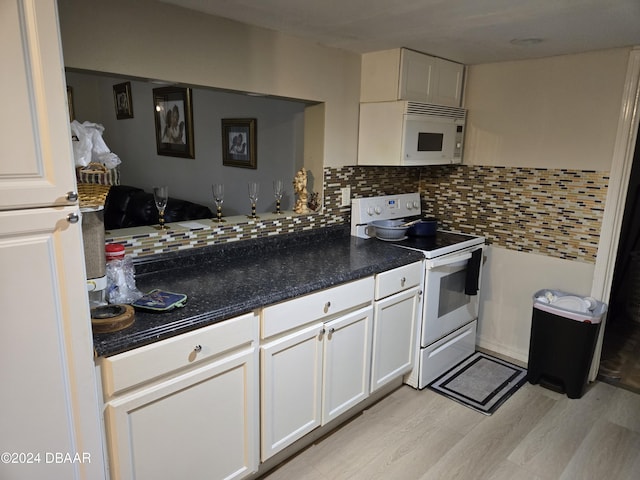 kitchen with decorative backsplash, white appliances, light hardwood / wood-style flooring, and white cabinetry