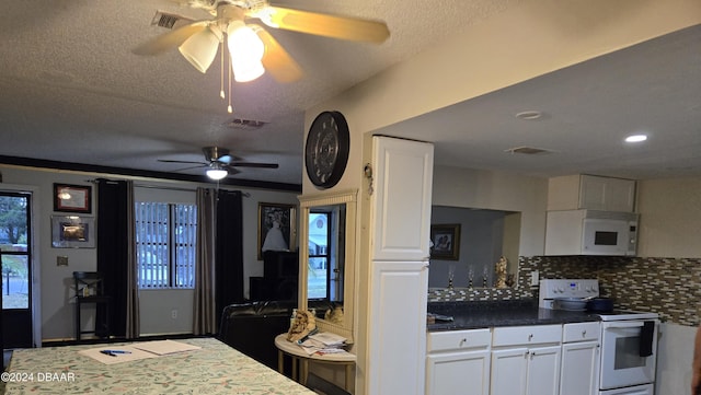 kitchen with ceiling fan, tasteful backsplash, a textured ceiling, white appliances, and white cabinets