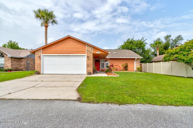 144 Herring Gull Ct, Daytona Beach, FL 32119 - view of front of home with an attached garage, driveway, brick siding, and roof with shingles