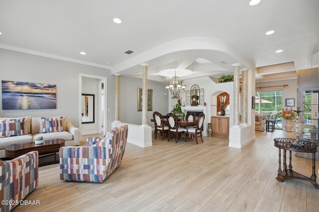 109 Edward Dr, Palm Coast, FL 32164 - living area with ornate columns, arched walkways, recessed lighting, light wood-type flooring, and a chandelier