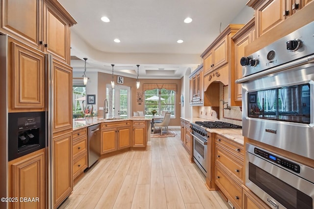 109 Edward Dr, Palm Coast, FL 32164 - kitchen featuring high quality appliances, a peninsula, light stone counters, recessed lighting, and light wood-type flooring
