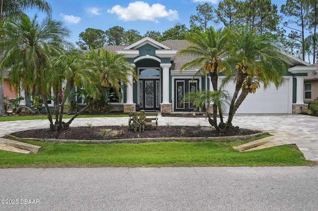 109 Edward Dr, Palm Coast, FL 32164 - view of front of house with curved driveway, an attached garage, and stucco siding