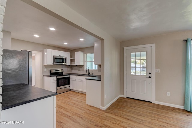 13 Highridge Rd, Daytona Beach, FL 32117 - kitchen with stainless steel appliances, dark countertops, healthy amount of natural light, and recessed lighting