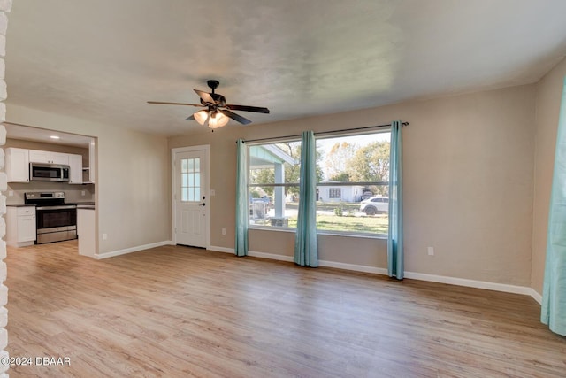 unfurnished living room with light hardwood / wood-style flooring and ceiling fan