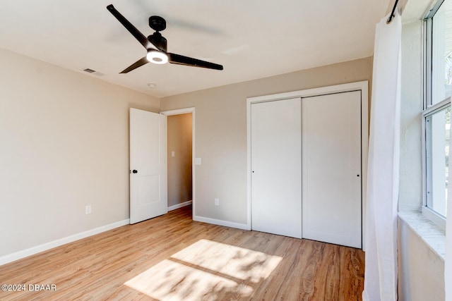 13 Highridge Rd, Daytona Beach, FL 32117 - unfurnished bedroom with wood finished floors, multiple windows, and a closet