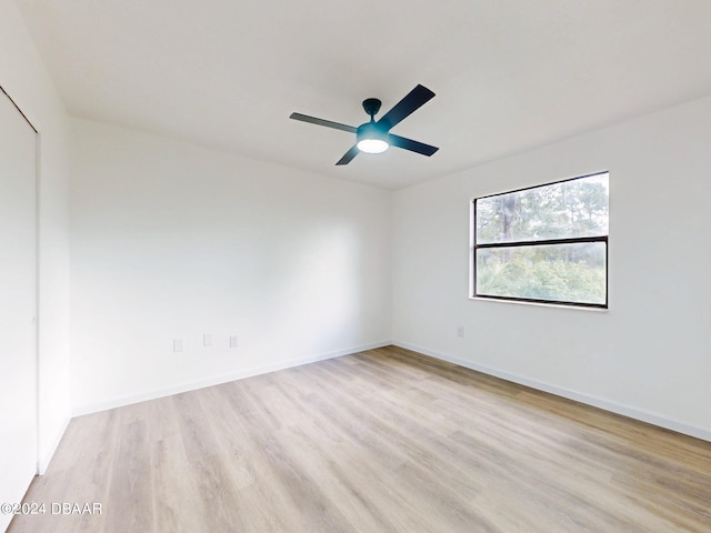 spare room with ceiling fan and light hardwood / wood-style flooring