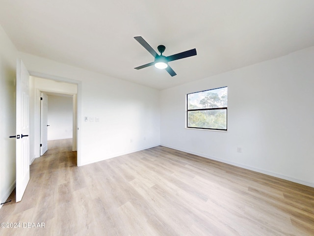 spare room featuring light hardwood / wood-style floors and ceiling fan