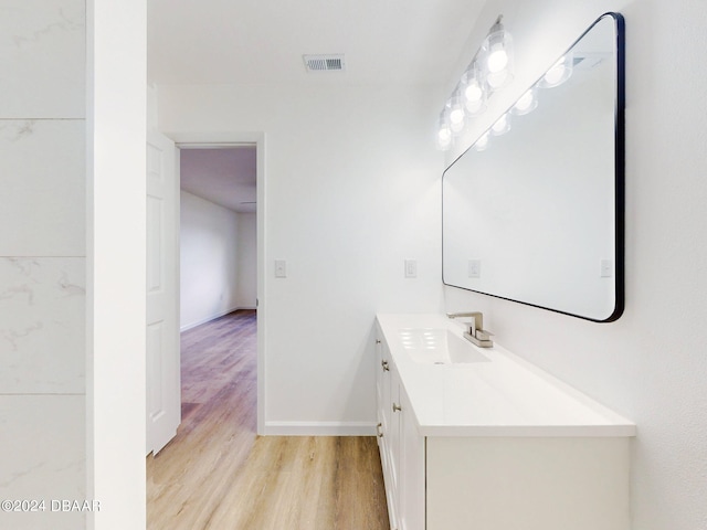 bathroom with hardwood / wood-style flooring and vanity