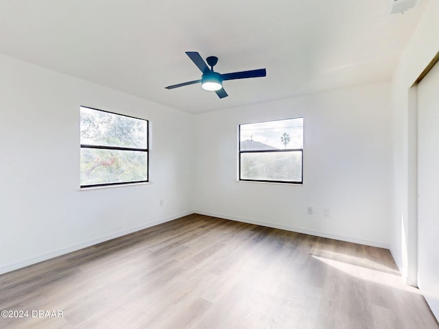 empty room featuring light wood-type flooring and ceiling fan