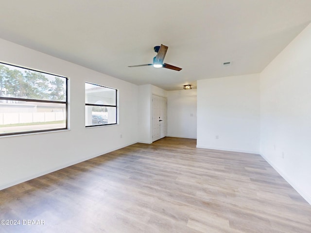 empty room with light wood-type flooring and ceiling fan